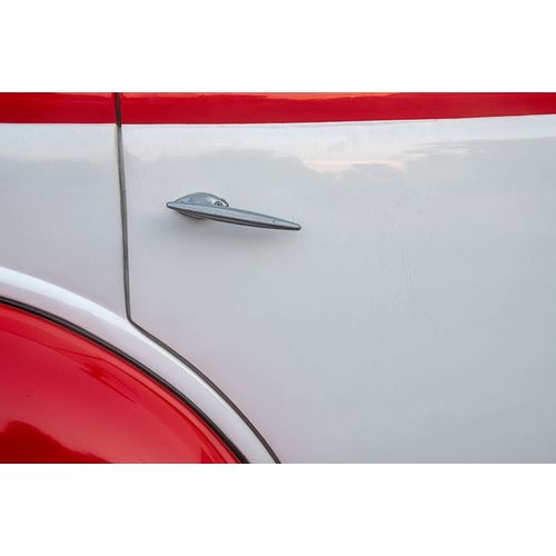 Detail of door on red and white classic American Ford in Habana-Havana-Cuba